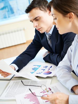 Business partners looking through papers at meeting
